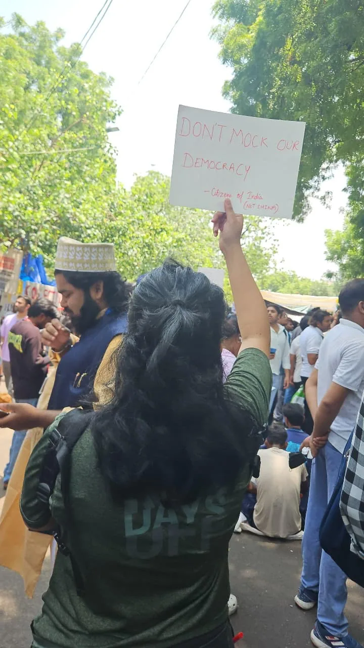 “Don’t mock our democracy” sign