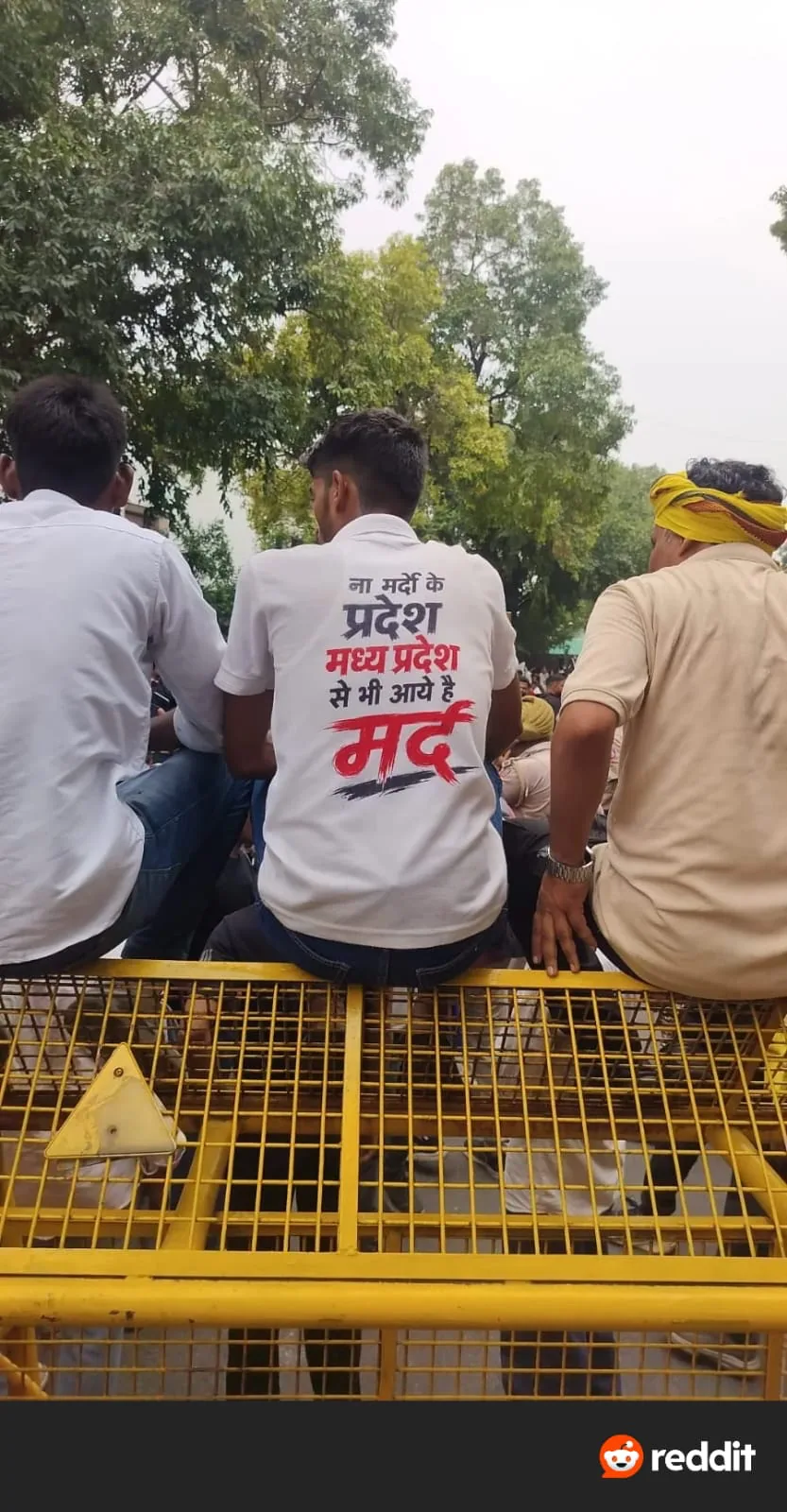 Youth seated on police barricade